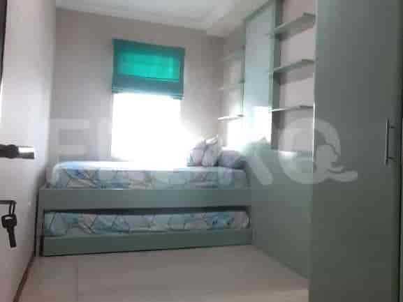 A bedroom with a bed and a sliding closet.