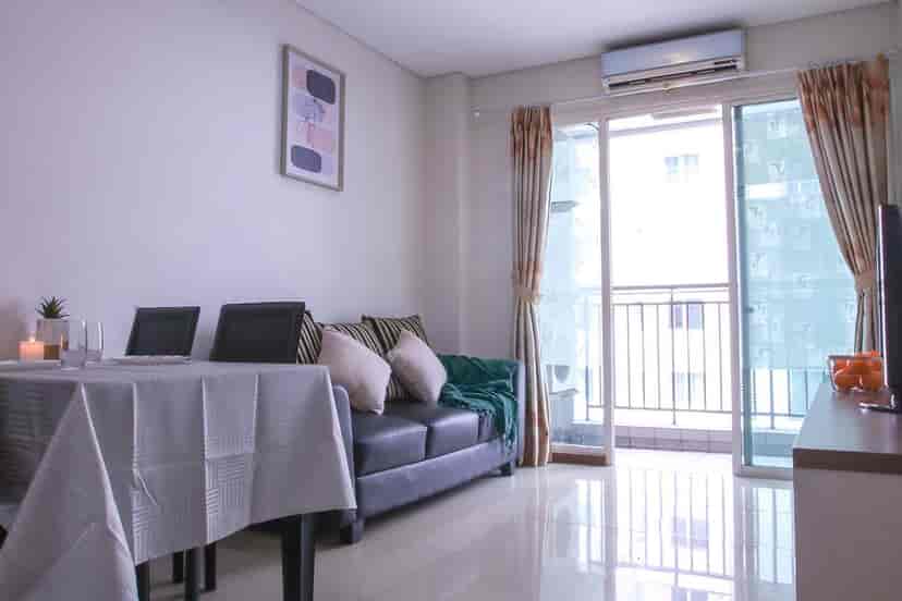 Spacious living room with dining area, a sofa and a view.