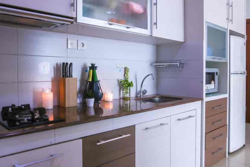 A modern kitchen with cooking and washing areas and a lot of equipment.
