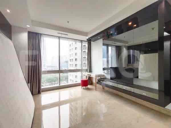 Living area with a large window, curtain, and partial view of the city.