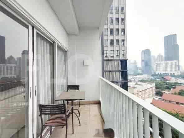 Balcony with a table, chairs, and city views.