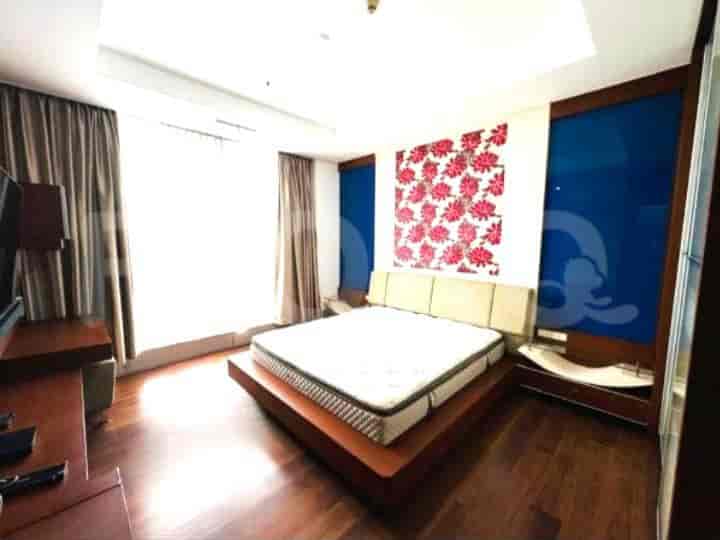 Bedroom with a large bed, floral wall art, and city view.