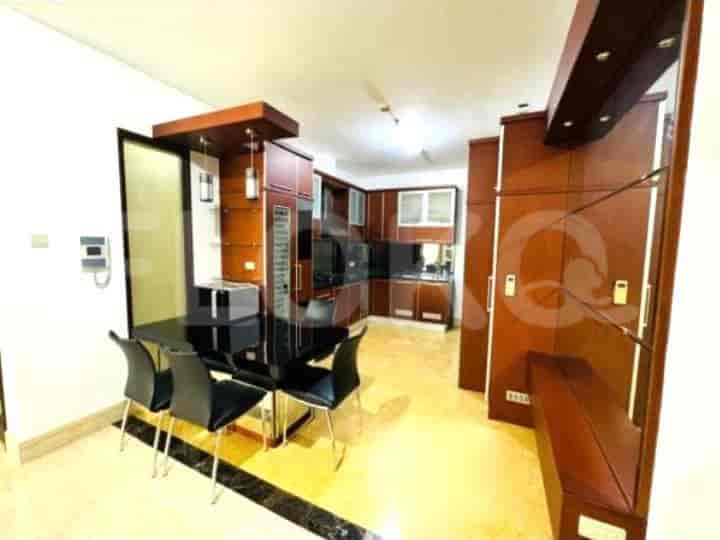 Kitchen and dining area with wooden cabinets and a black dining table.