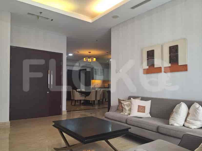 Modern living room with grey sofa, wooden coffee table, and art.