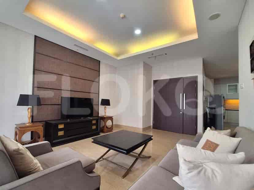 Living room with TV, sofa, and lamps.