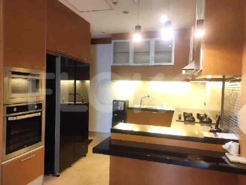 A modern kitchen with wood cabinets and stainless steel appliances.
