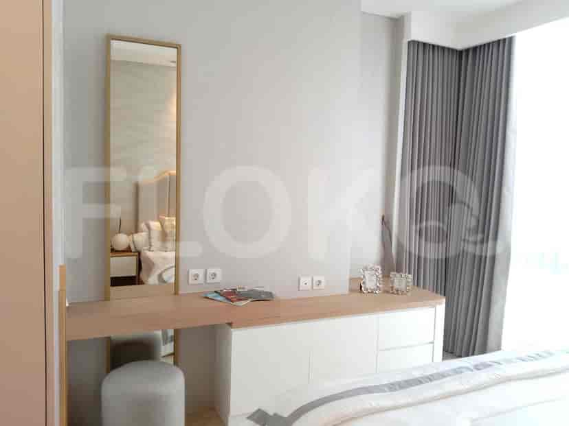 Vanity area with a mirror, desk, and stool.
