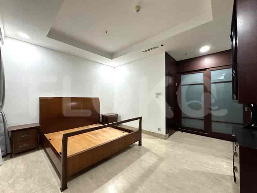 A bedroom with a wooden bed and nightstands.