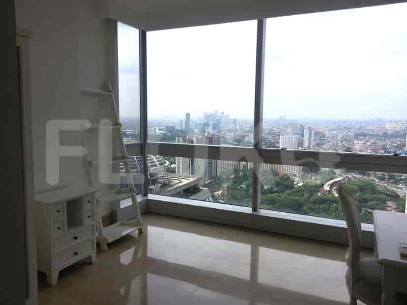 A bedroom with a city view and access to the dining room and kitchen