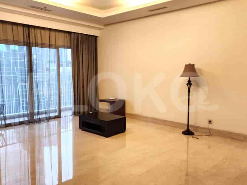 A spacious living room with a coffee table, side table, and floor lamp.