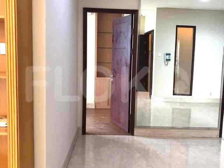 Hallway with doorways, and a glimpse of a room.