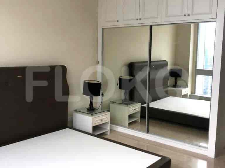 Bedroom with a bed, sliding closet doors, and nightstands.