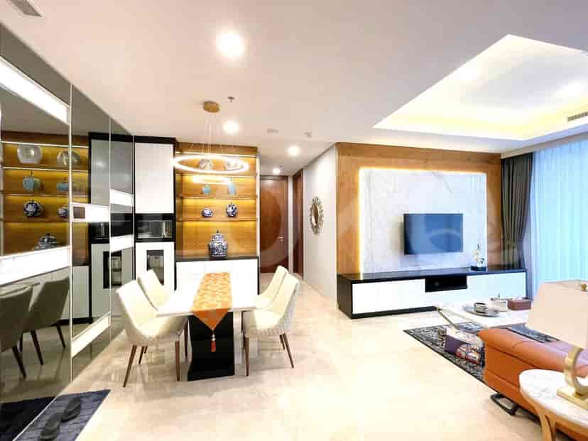 Elegant living and dining space with marble floors, a dining table, and a built-in entertainment unit.