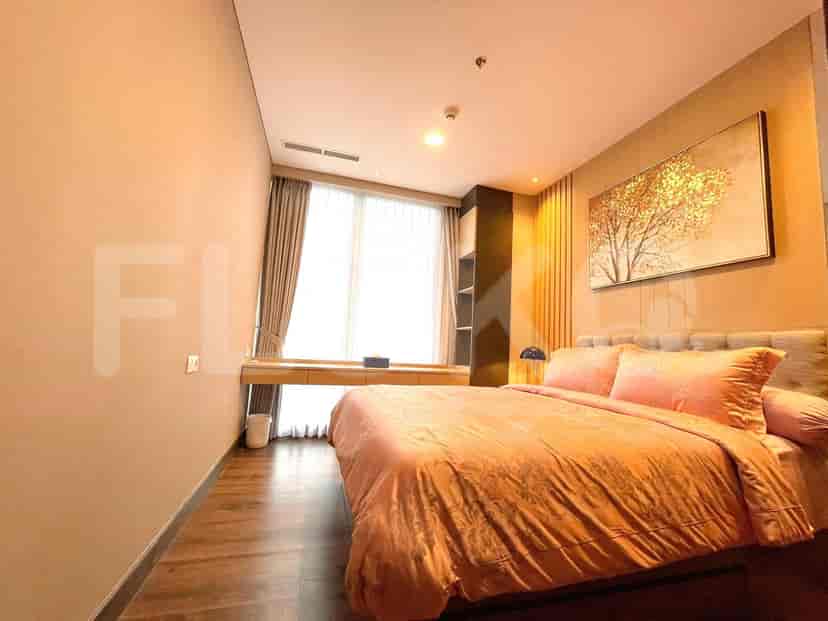 Cozy bedroom with a double bed, desk, and artistic wall decor.