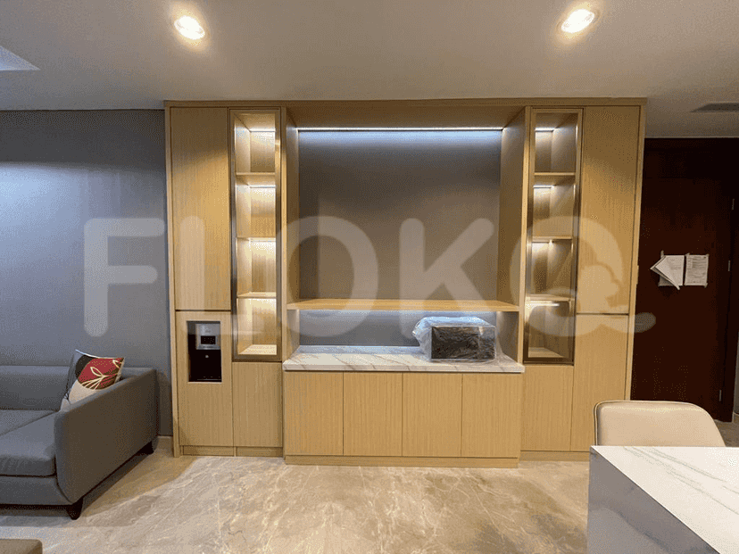 A built-in entertainment unit with storage, shelves, and a hidden water dispenser.