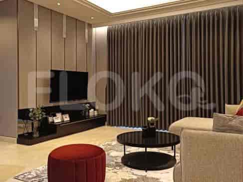 A luxurious living room with a dark TV console, grey sofa, and elegant curtains.