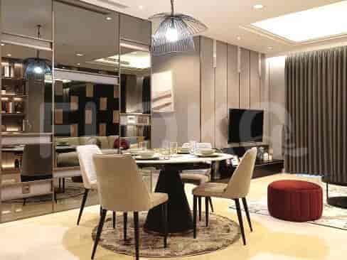 A dining room setup with a table, chairs, and decor.