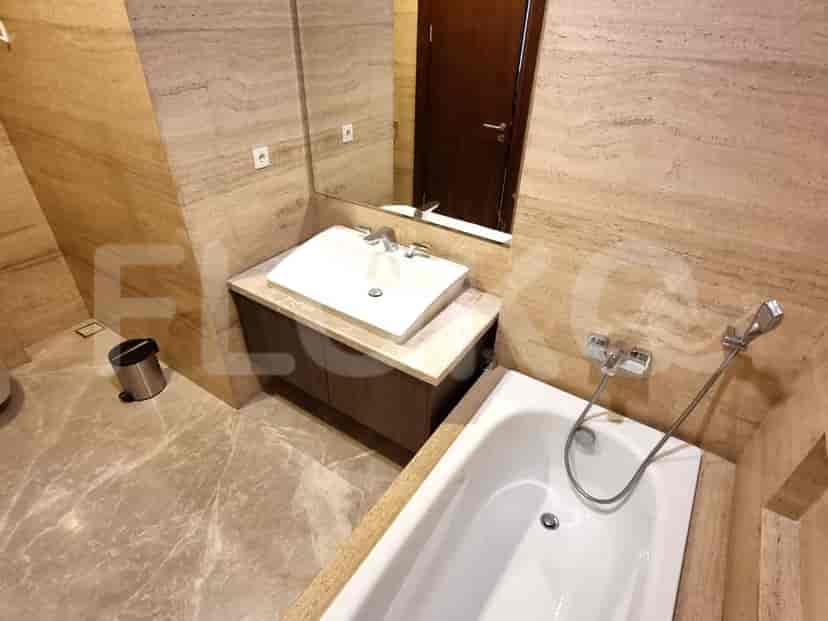 A luxurious bathroom with a bathtub, sink, and large mirror.