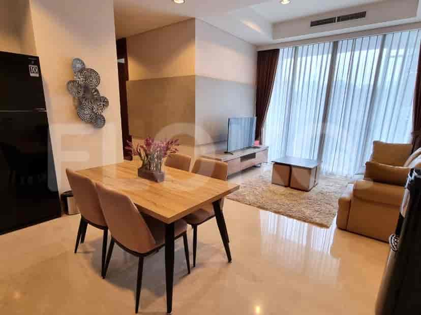 An open-concept living and dining area with a dining table and sofa.