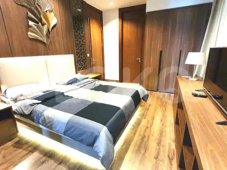 Stylish bedroom with a king bed, wooden accents, and a TV.