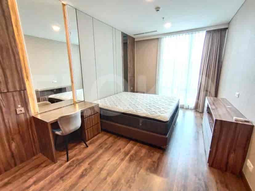 Another bedroom with a bed, desk, and a neutral color scheme.