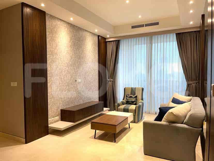 Living room with entertainment unit, striped armchair, sofa, and a large window.