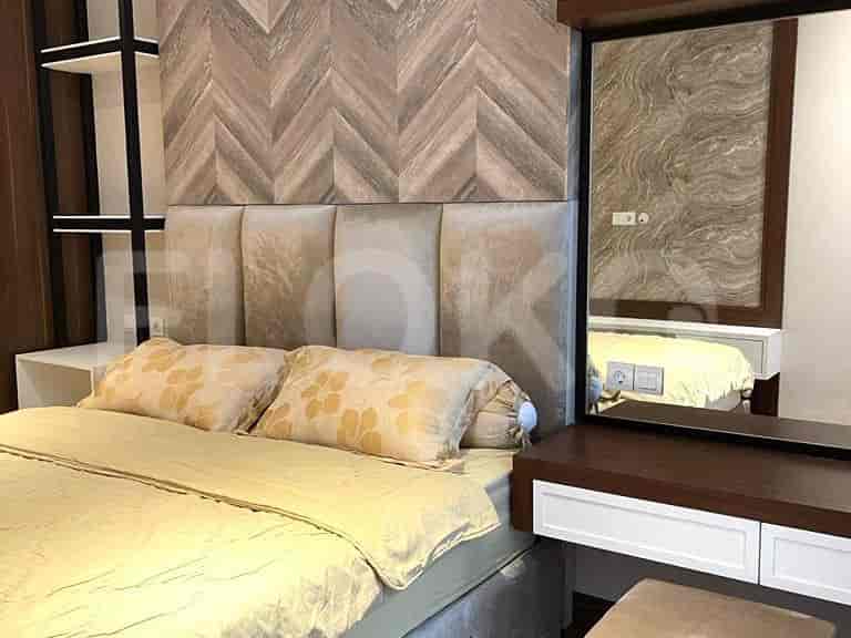 Bedroom with a bed, dresser, and wall decor.