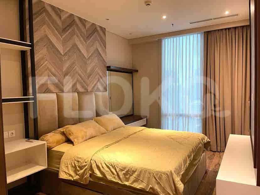 Bedroom with a bed, wall decor, and curtains.