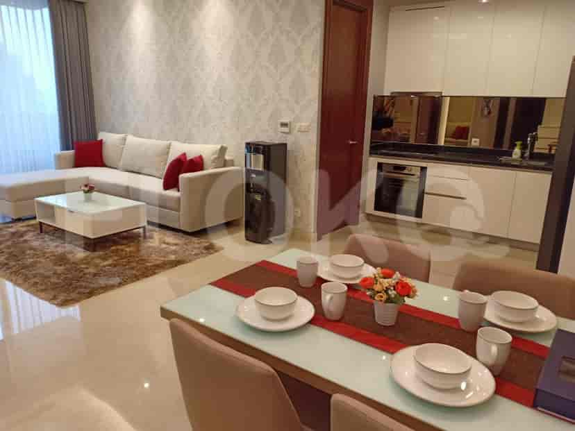 Combined living and dining area with a modern kitchen and dining set.