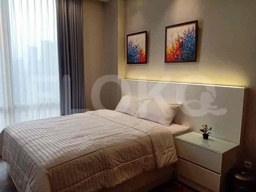 A second bedroom with art and a comfortable bed.