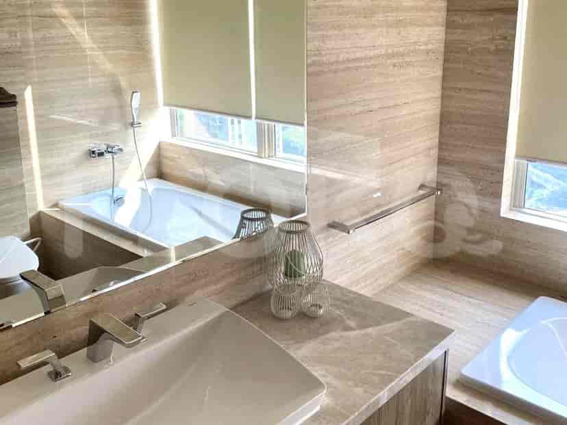 A modern bathroom featuring a bathtub, sink, and a large mirror.