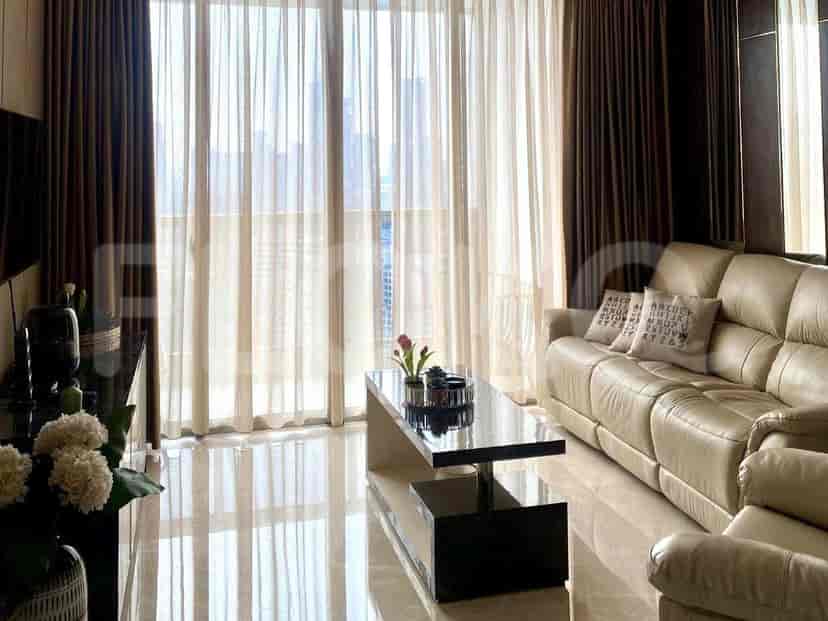 A bright bedroom with a comfortable bed, large windows, and a city view.