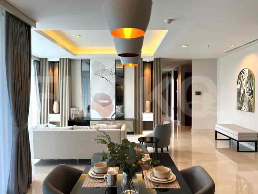 A combined living and dining area with a sofa, art, and dining table.