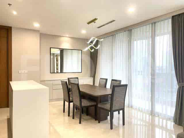 A dining area with a dining table and city view.