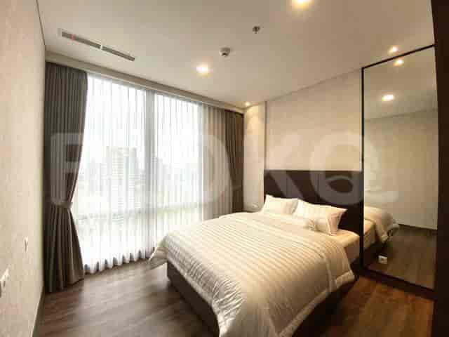 A bedroom with a king size bed and a city view.