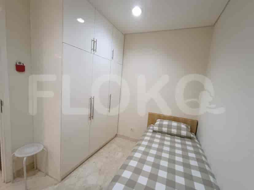 Compact bedroom with a single bed and ample storage.