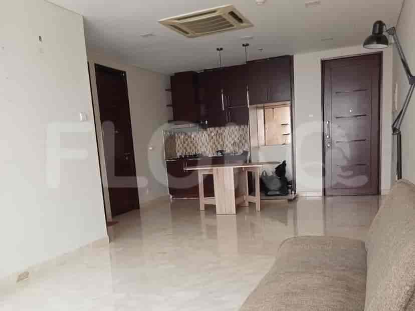 Open-plan kitchen and living area with a dining table.