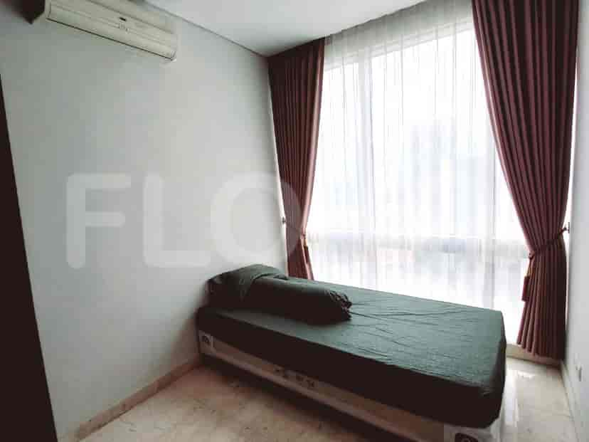 A bedroom with a single bed and a wardrobe.