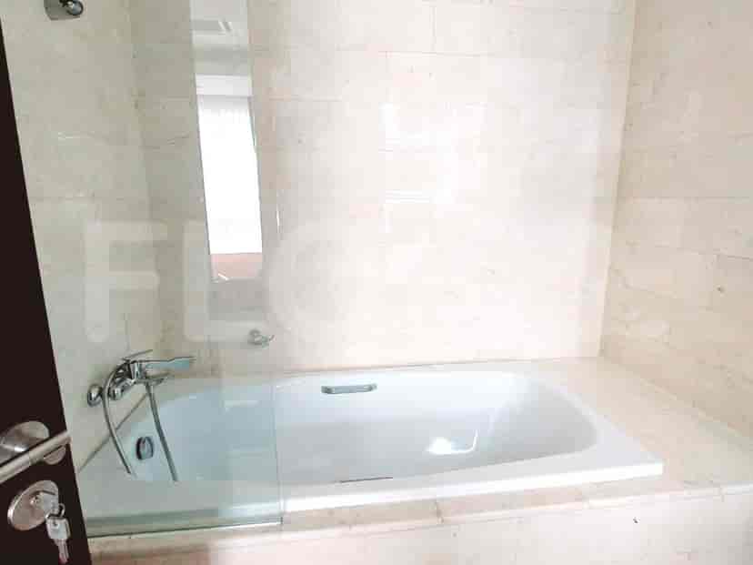 A bathroom with a bathtub and a mirror.
