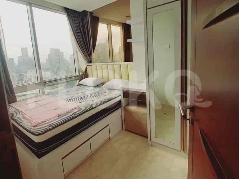 Bedroom with large windows and contemporary furnishings.