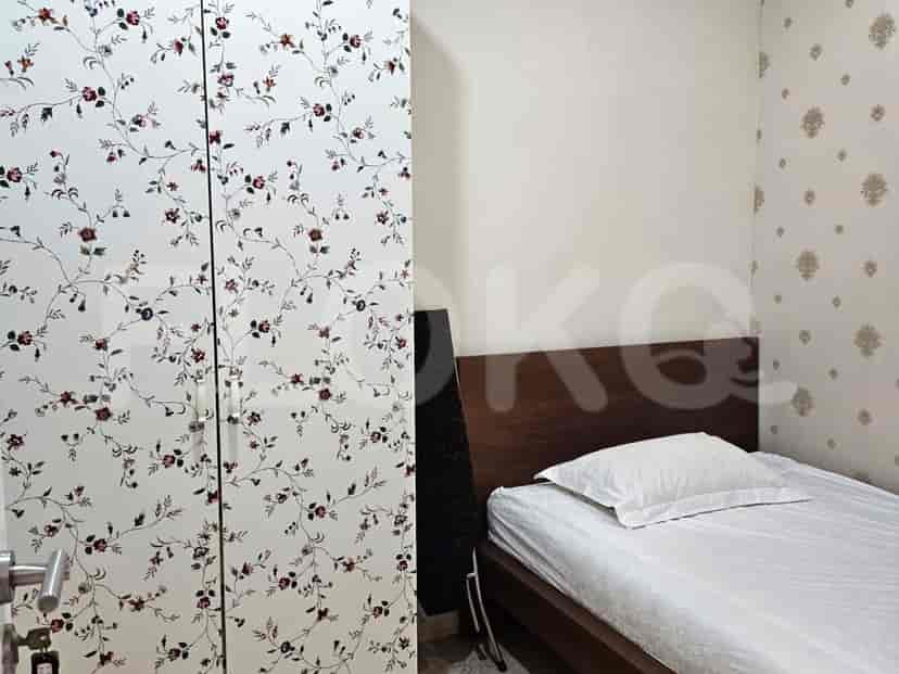 Bedroom with a single bed and a floral wardrobe.
