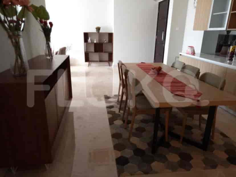 Dining room featuring a long dining table, a buffet, and a decorative rug.