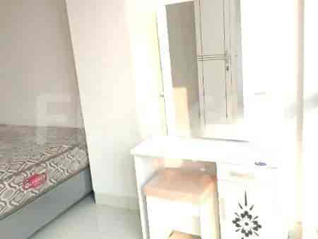A close-up view of a dressing table with a stool.