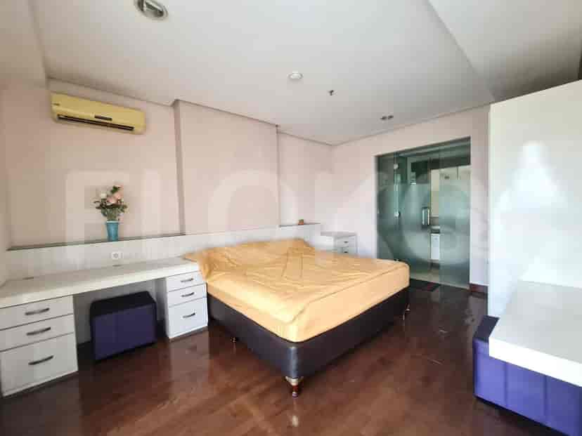 Bedroom interior showing bed and a bathroom entrance.