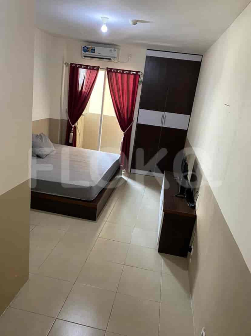 Bedroom with bed, TV, and AC unit.