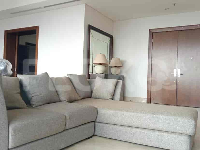 A living room with a large sectional sofa and a modern design.