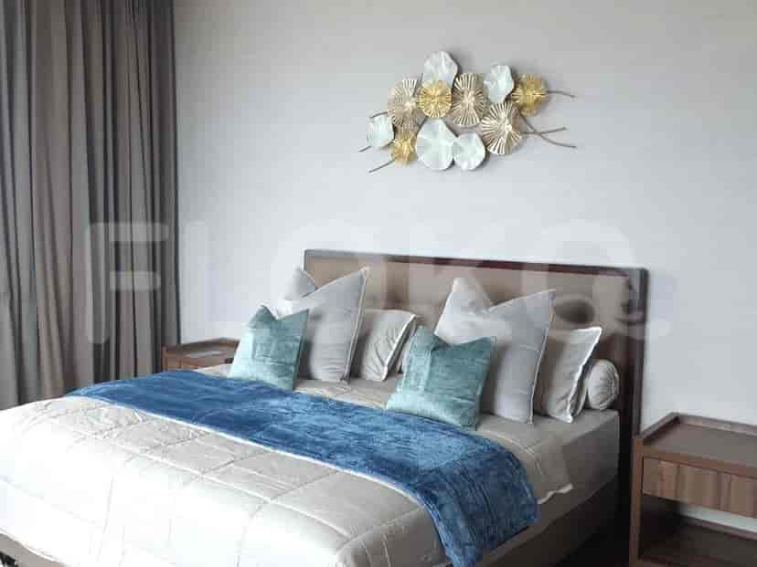 Spacious bedroom with a large bed, artwork, and neutral color scheme.