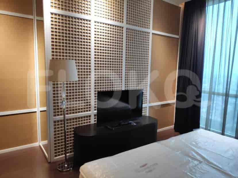 A contemporary bedroom with a stylish design and a flat-screen TV.