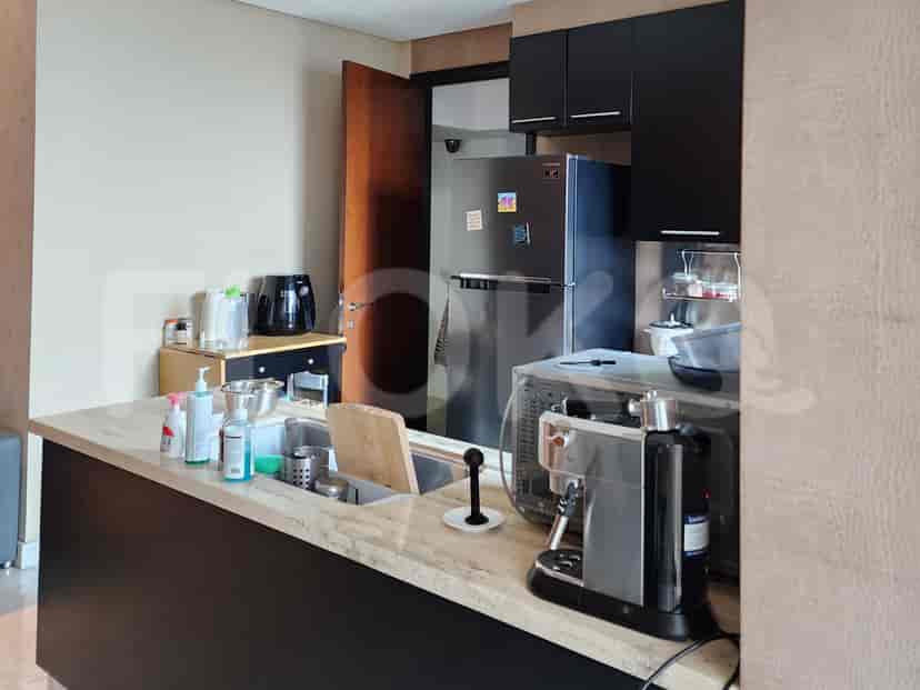 Modern kitchen featuring a bar, appliances, and sleek cabinetry.