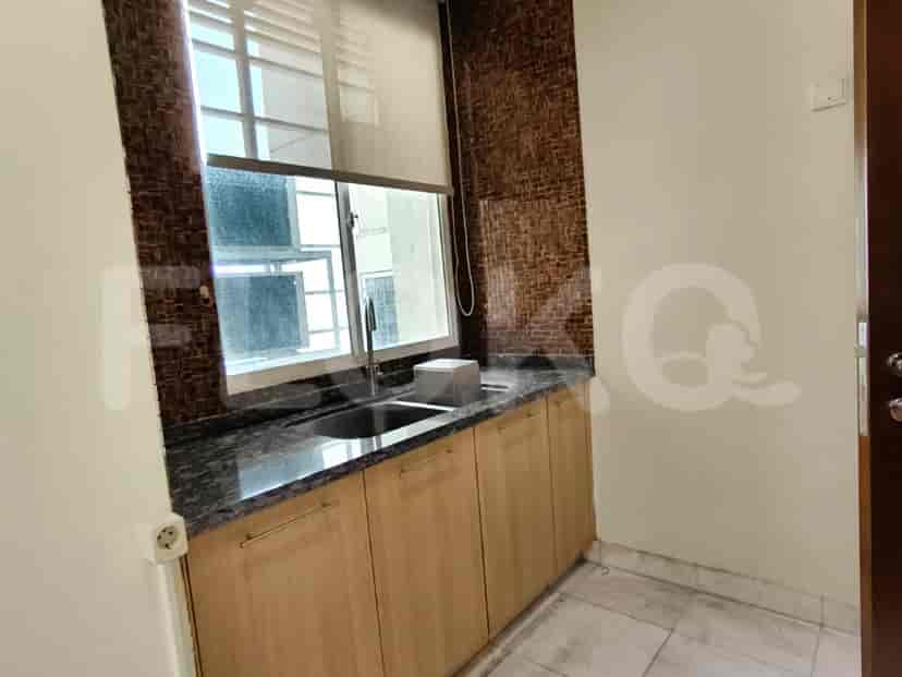 A kitchenette with a sink and cabinets.